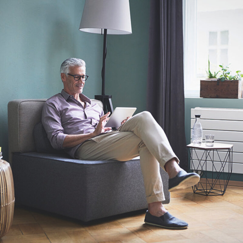 Mature man using tablet at home